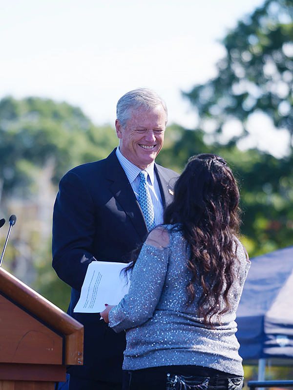 Rachel Casey accepting congratulations from Governor Baker