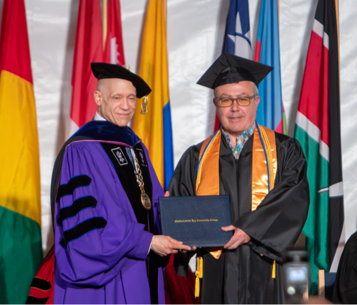 MassBay President Dr. David Podell gives diploma to Arthur Nigro