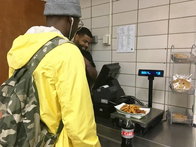 Student buying food in MassBay Cafeteria