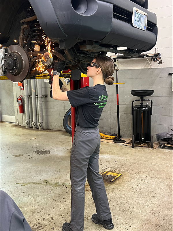 Automotive Tech student Daria Litouka working on car