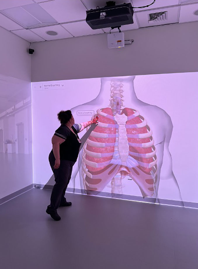 immersion room with large walk-through projection images of bodies