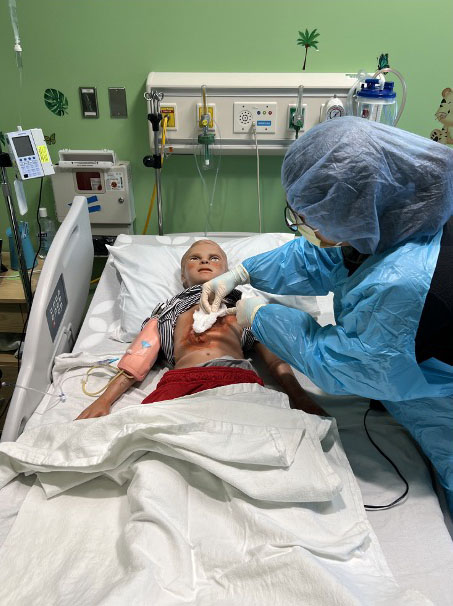 child health simulator figure and professional protective gear