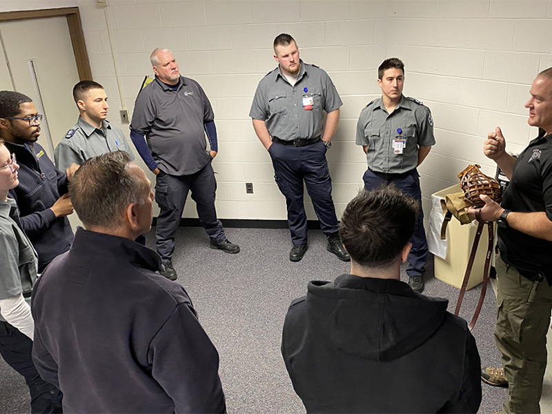 Massachusetts State Police Sgt. David Stucenski (right) explains muzzle techniques to MassBay Community College EMS students, Framingham, MA, February 2023 (Photo/MassBay Community College).