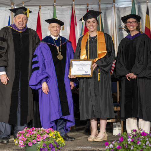 James J. McKenzie, Esq. of the Foundation Board and President Podell on Stage at 2026 Commencement MassBay