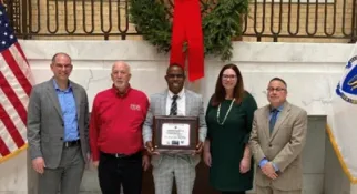 Pictured from left to right, Division of Capital Asset Management and Maintenance Commissioner Adam Baacke, MassBay Director of Facilities Joe DeLisle, MassBay Vice President of Finance and Administration Marcus Edward, Elizabeth Mahony Department of Energy Resources Commissioner, and Leading by Example Program Director Eric Friedman