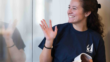 Student smiling/waving
